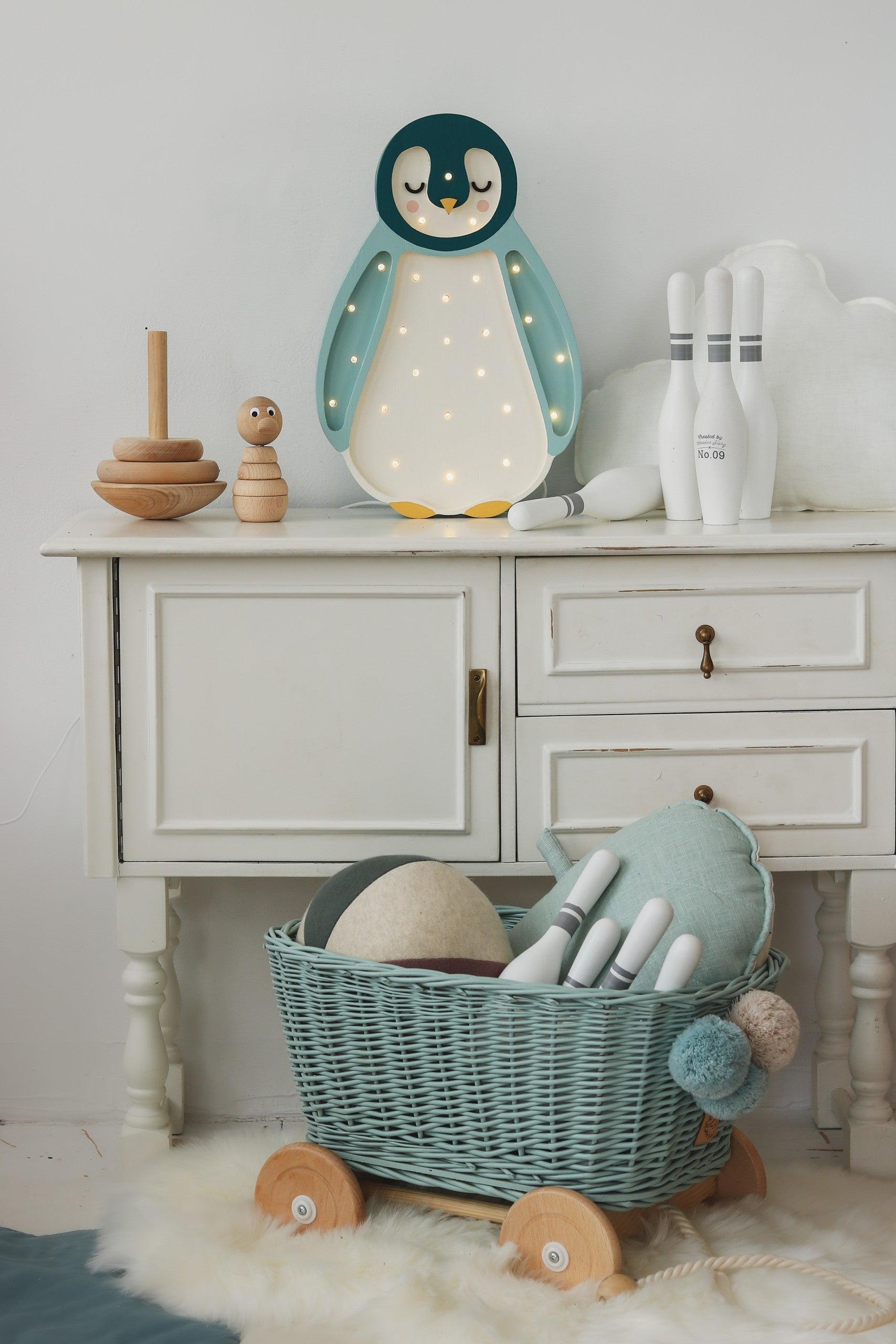 bold artisan-made penguin lamp in solid pinewood casting a warm glow for kids