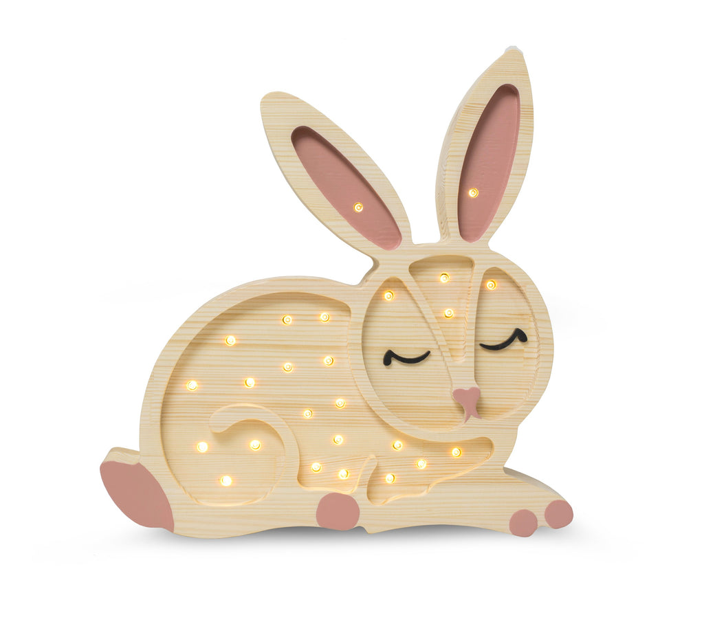 handmade pine bunny lamp casting a warm glow on a nursery shelf