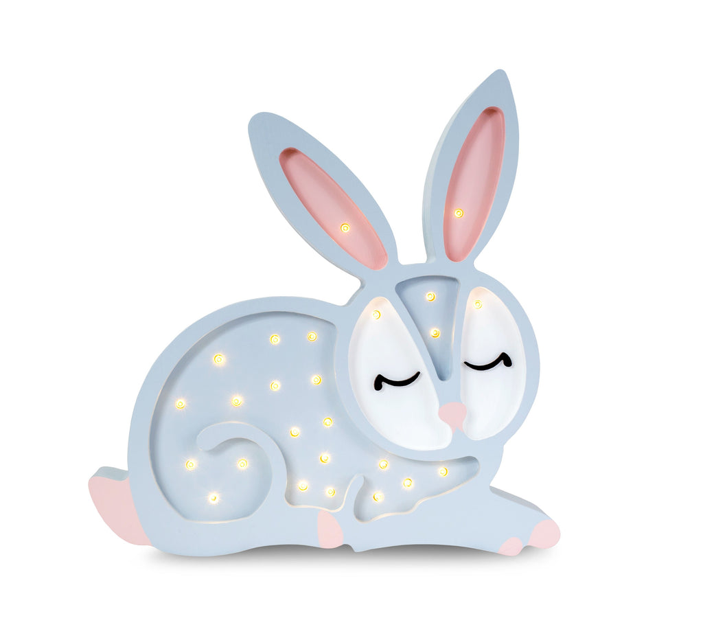 handmade pinewood bunny lamp casting a soft glow on a nursery shelf