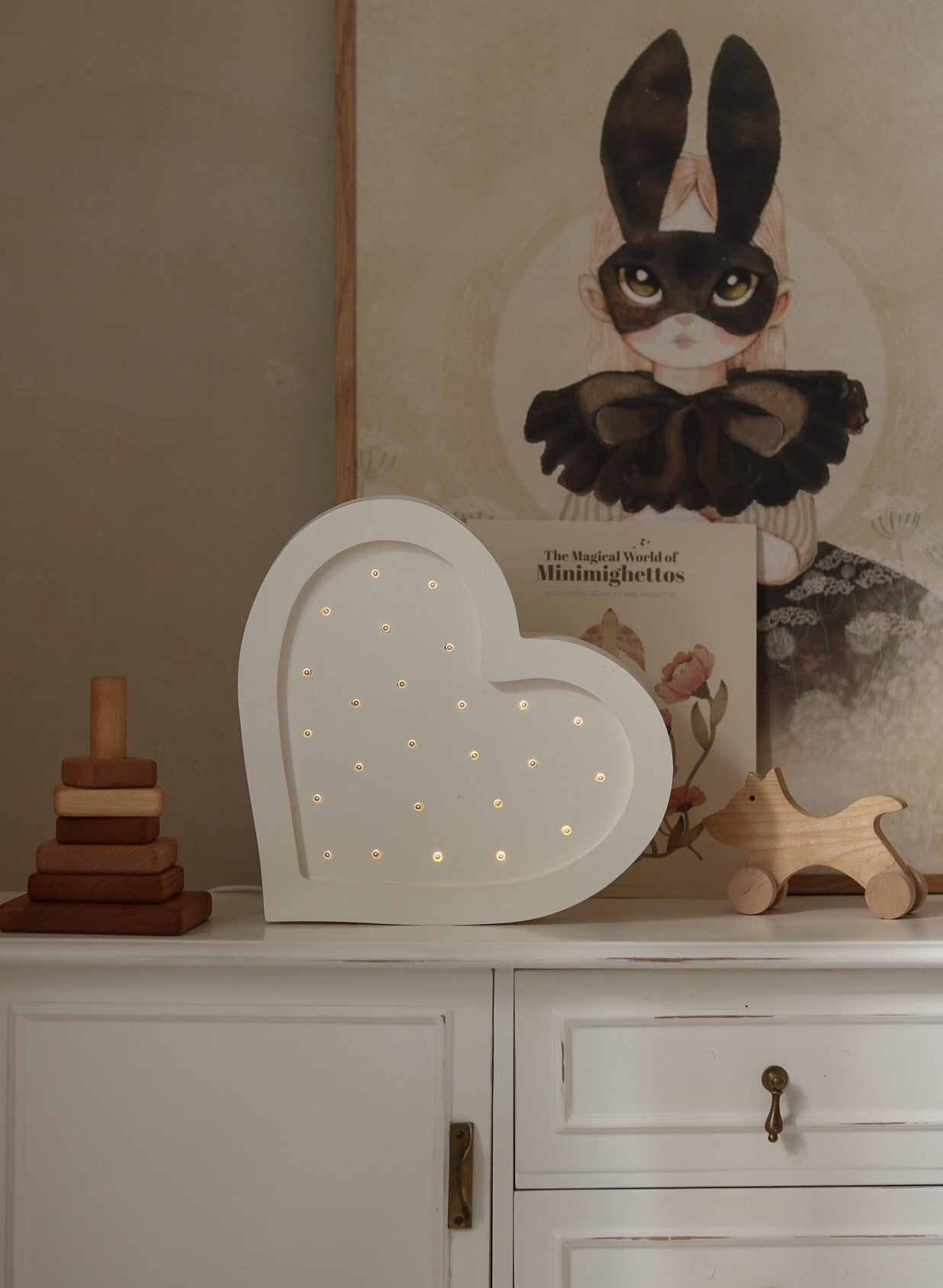 elegant solid pinewood heart lamp casting a refined, warm glow in a child's serene bedroom