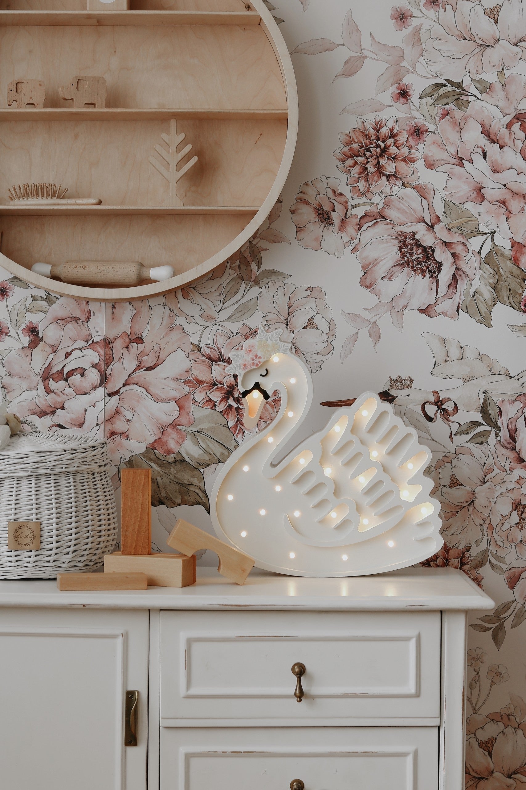 playful wooden swan lamp casting a warm glow on a childs bedside table