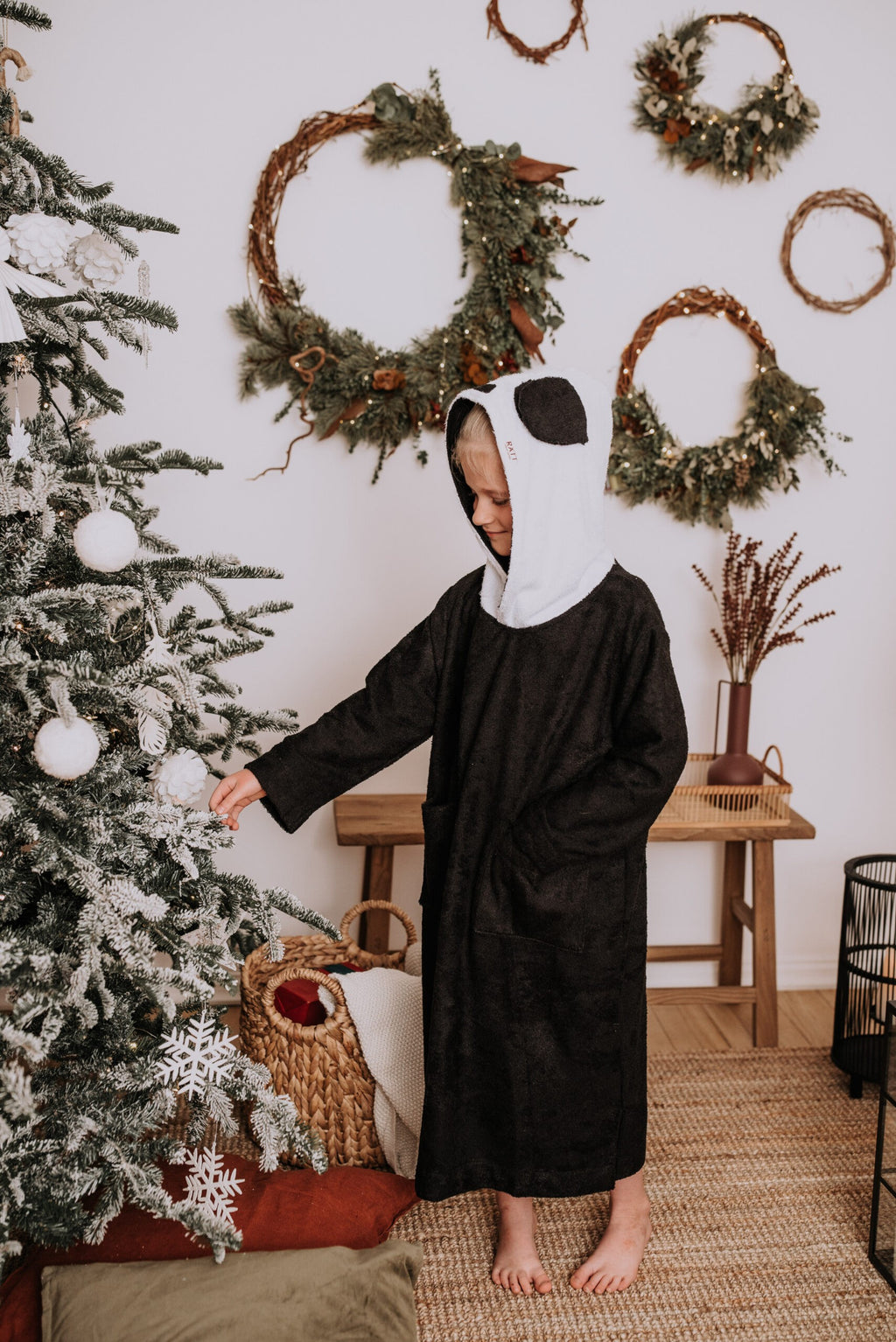 confident child in a cozy bamboo panda poncho with a bold hood and pockets