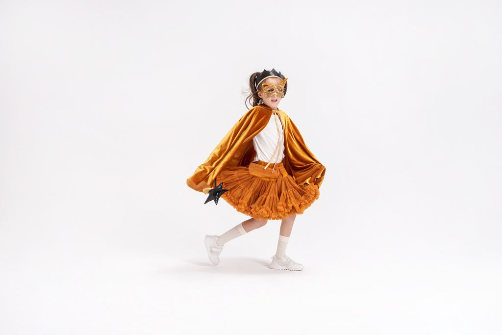 soft golden velour kids cape with a cozy hood and secure snap closure