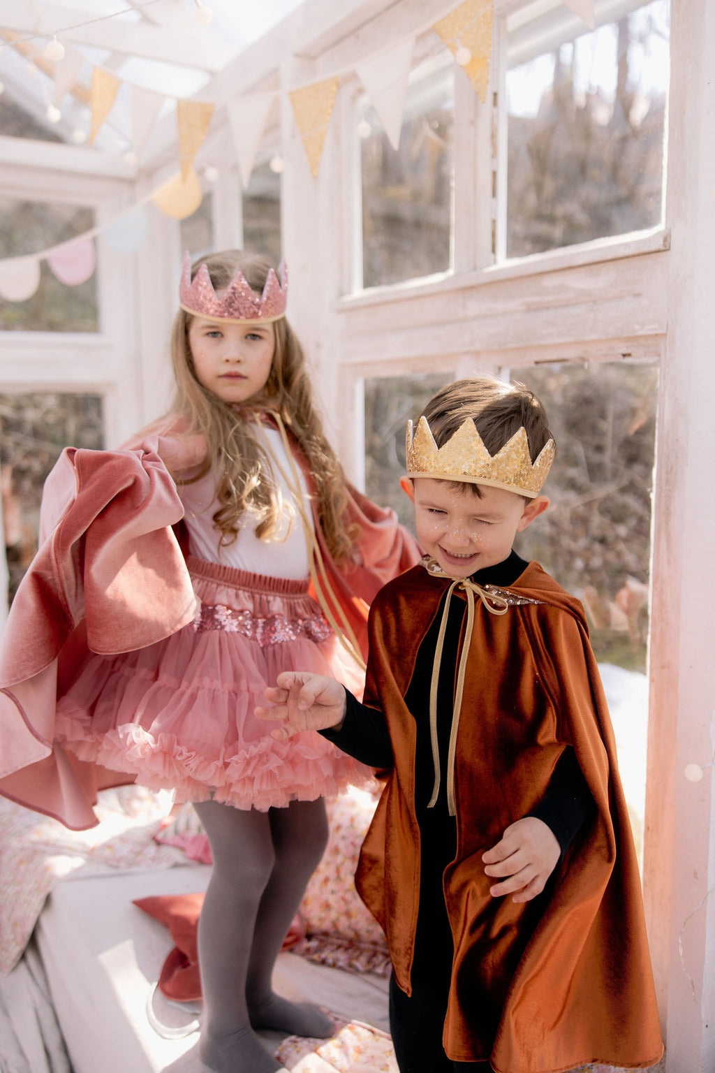 pink velour magic cape with deep hood and snap fastening, perfect for fairy tale adventures and playful dress-up