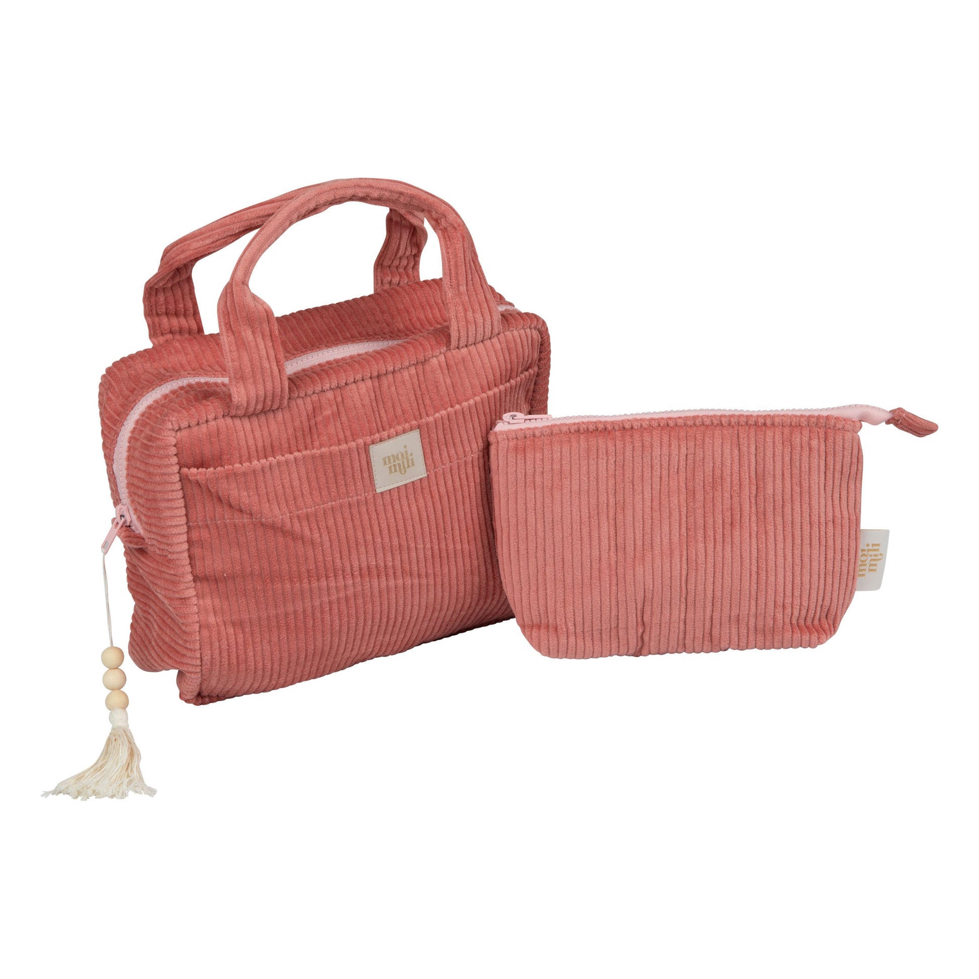bold chic coral makeup bag set open on a marble surface showing its spacious interior and pockets