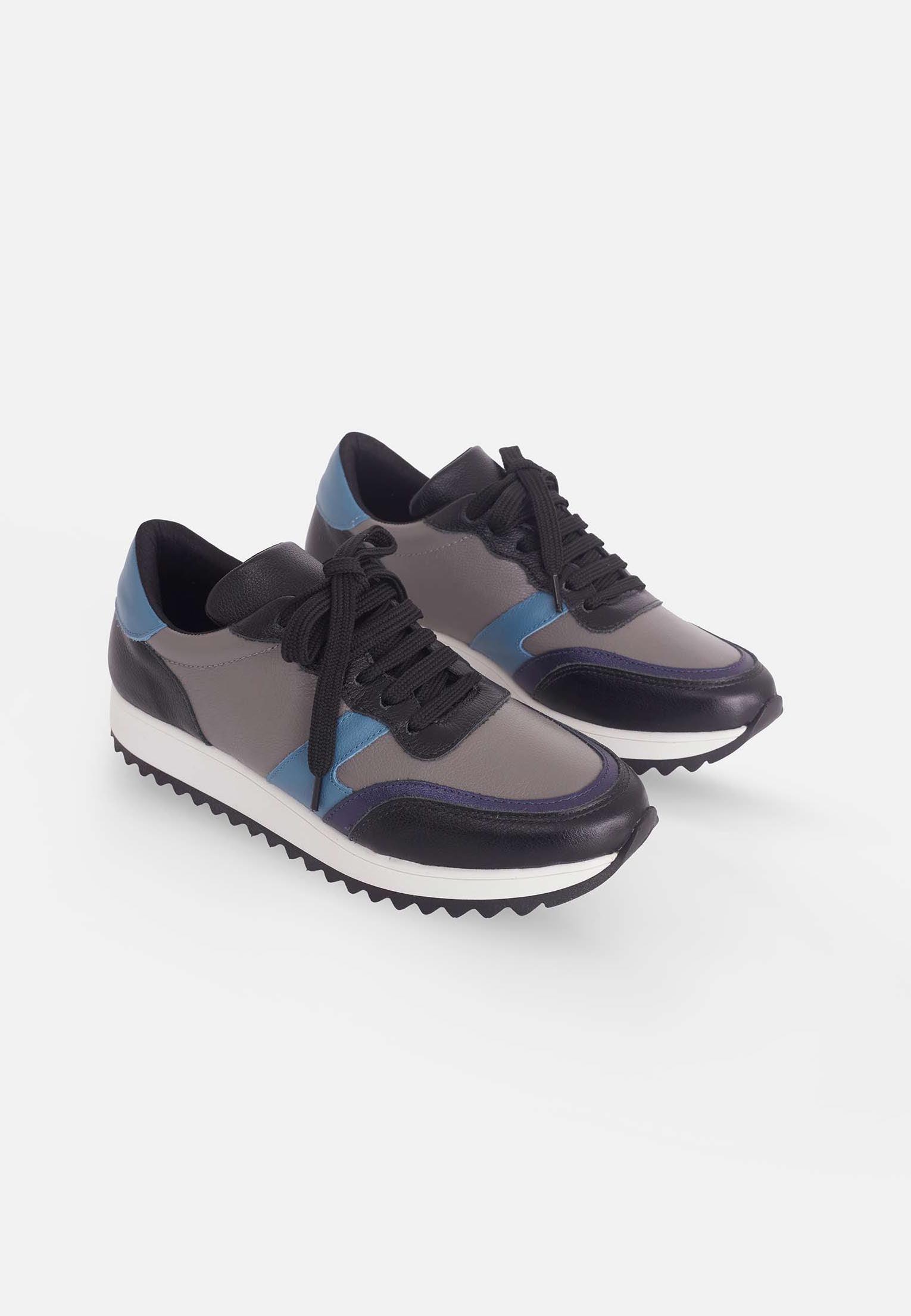 soft grey and blue mangara sneakers on a cozy textile background