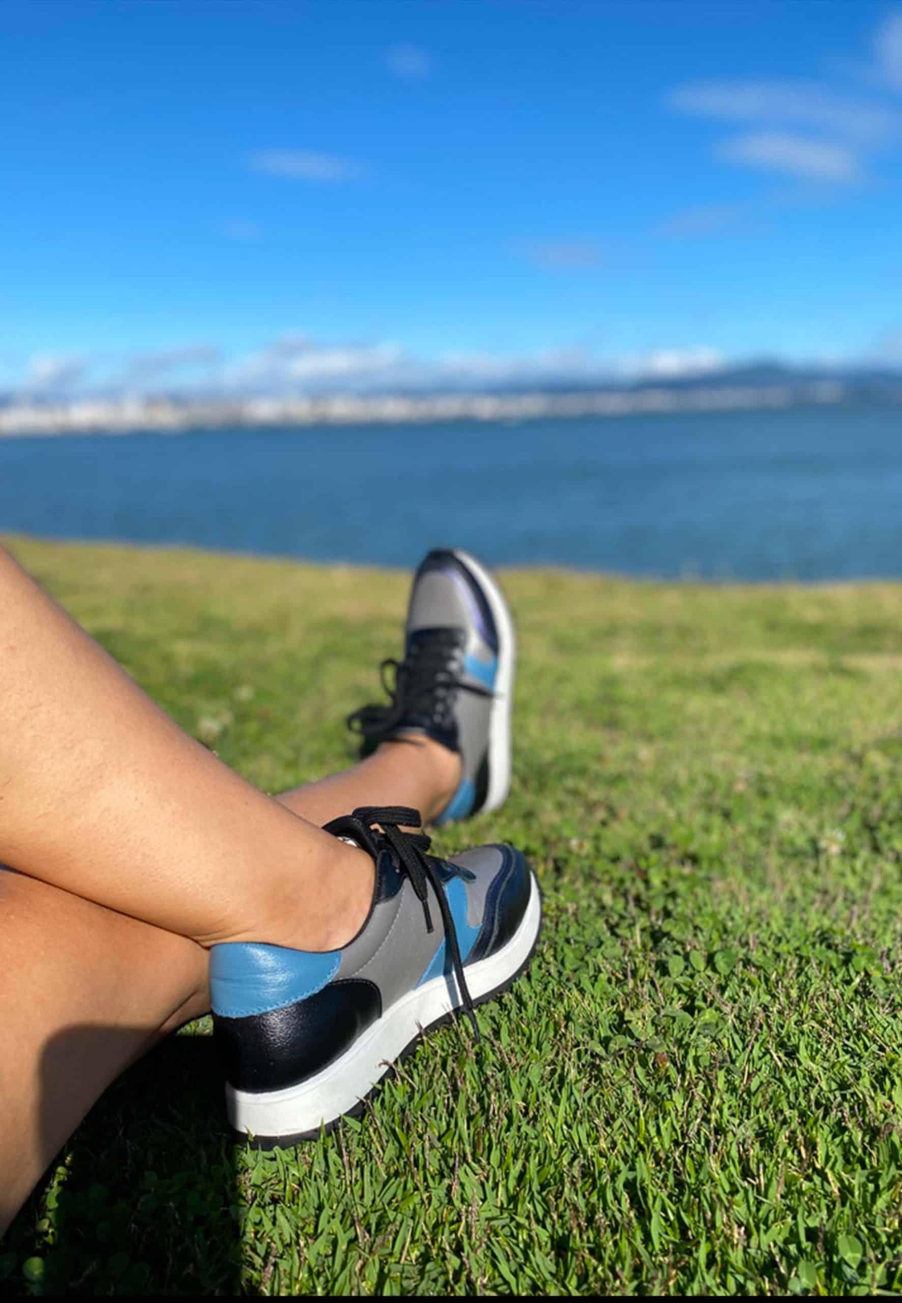 mangara buriri women's leather sneaker side profile on a city sidewalk, showcasing its durable rubber sole and practical low-top design