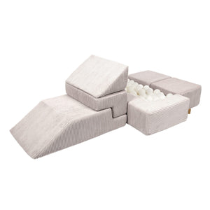 a bold modular play sofa in soft ecru velvet configured into a striking modern throne