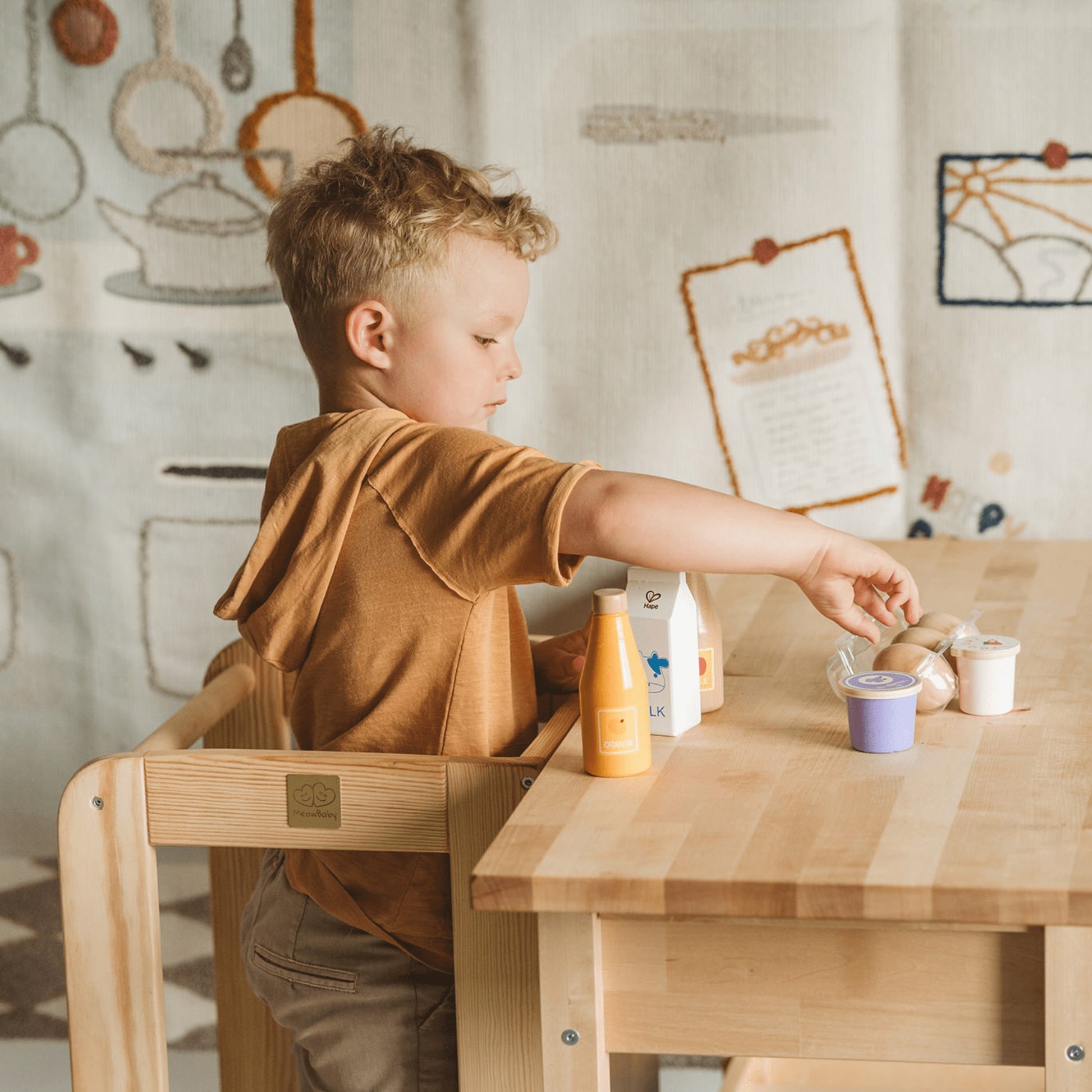 elegant natural wood kitchen helper stool for kids in a refined, sunlit home setting