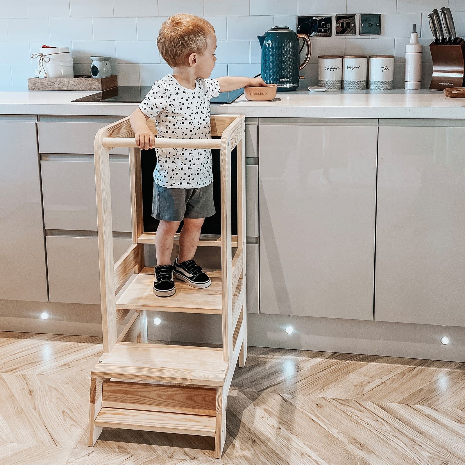 confident toddler reaching kitchen counter on a sturdy meowbaby wooden helper tower
