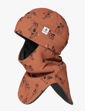 a confident child in a copper dogs merino balaclava, bold against a crisp winter backdrop