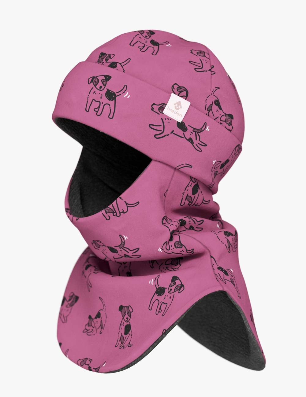 a soft pink kids balaclava with a playful dog pattern, shown in gentle morning light