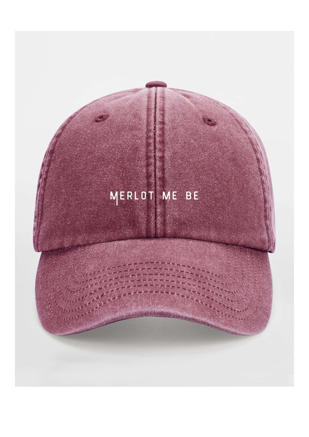 a bold merlot me be cotton cap in dramatic low-key lighting, showcasing its confident, unstructured shape