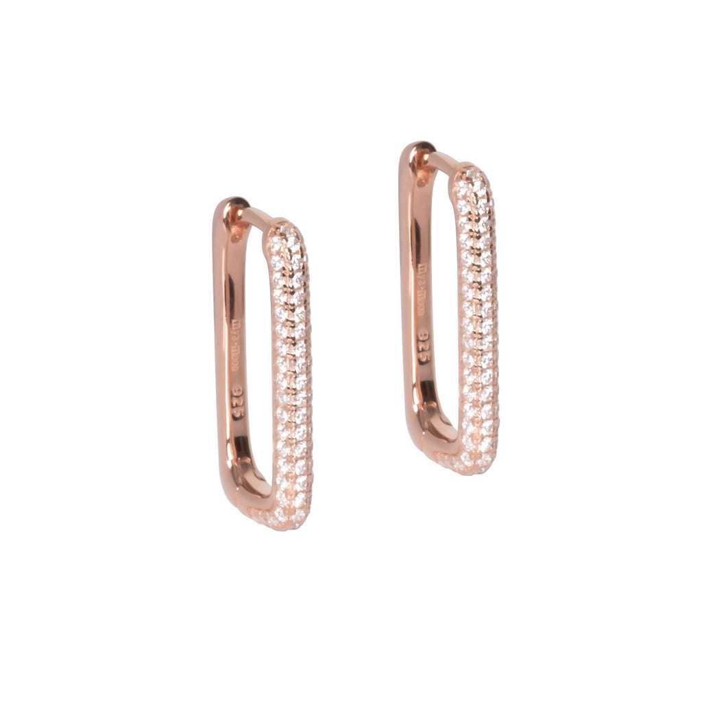 playful close-up of sterling silver hoop earrings with sparkling white zircons catching the light