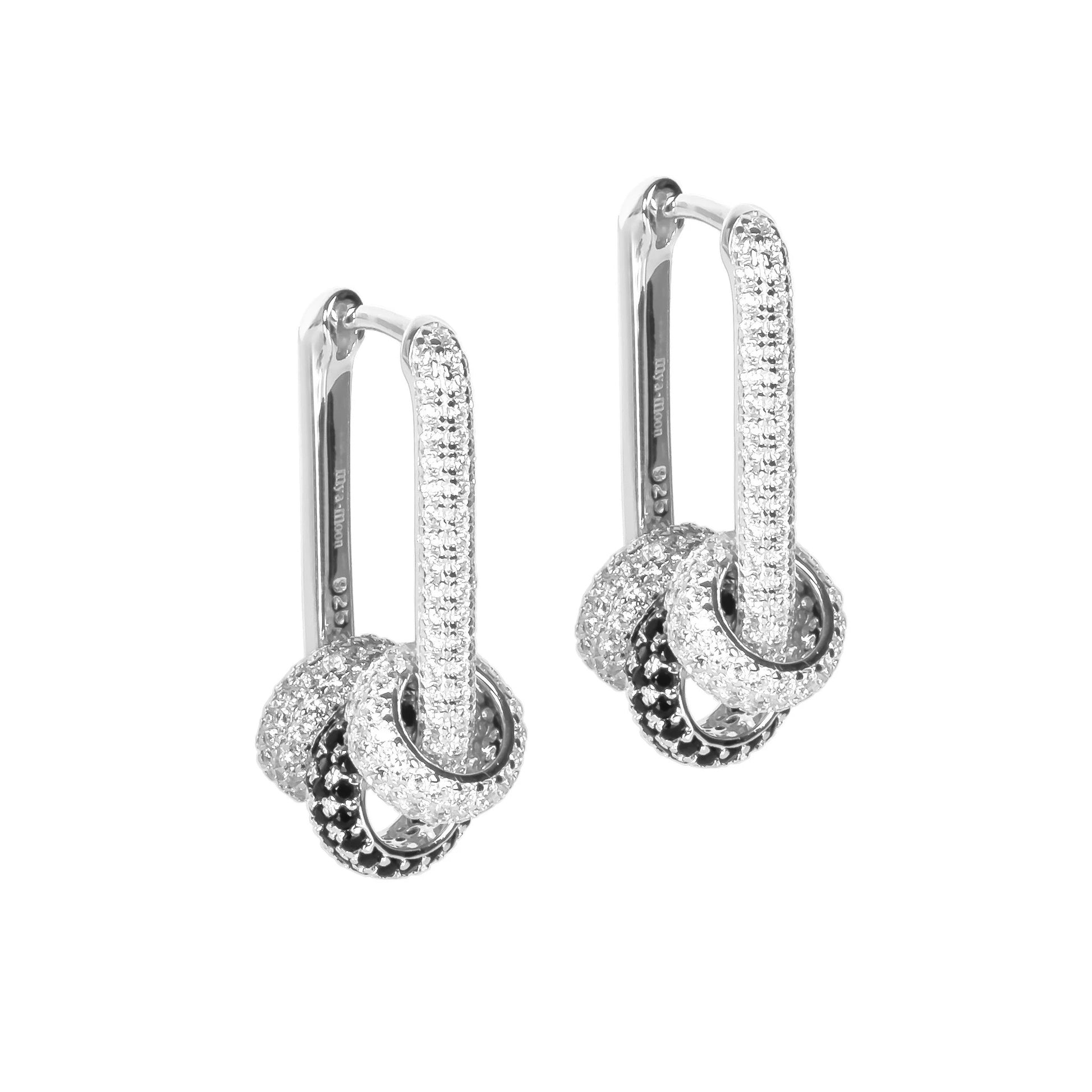 bold convertible hoop earrings with white zircons catching dramatic studio light