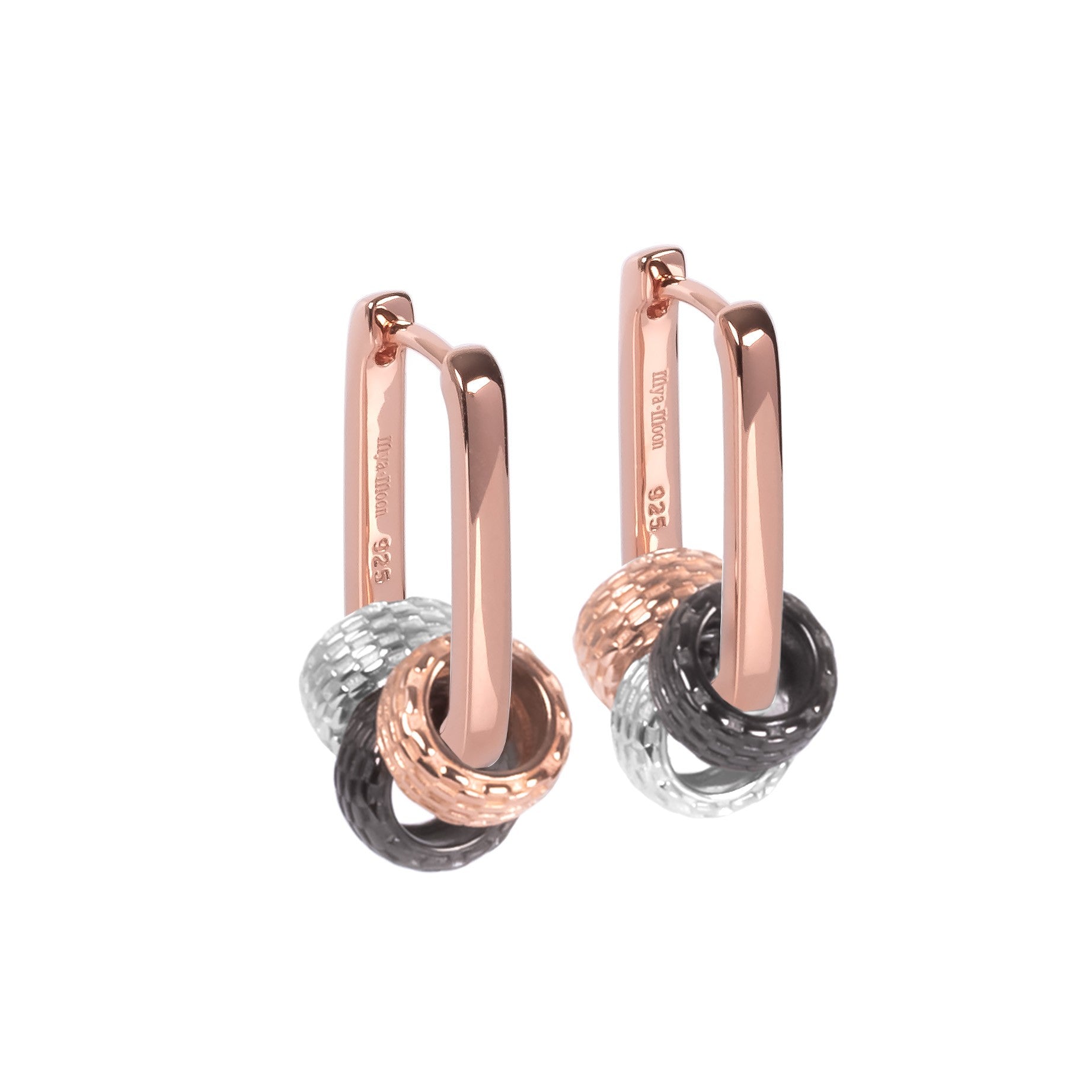 playful close-up of sterling silver metropolitan charm hoops with three detachable charms catching the light