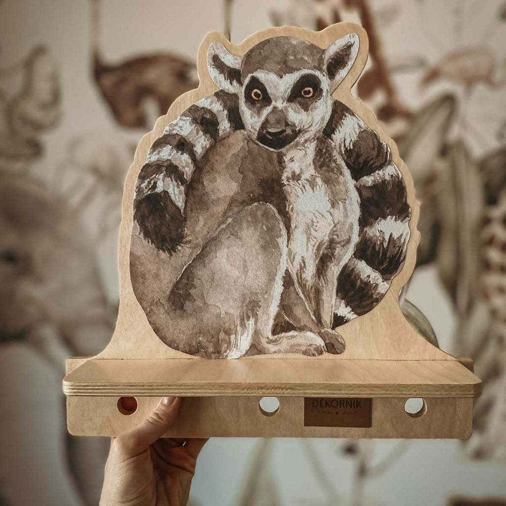 playful lemur wall shelf with three pegs for hanging kids accessories in a bright room