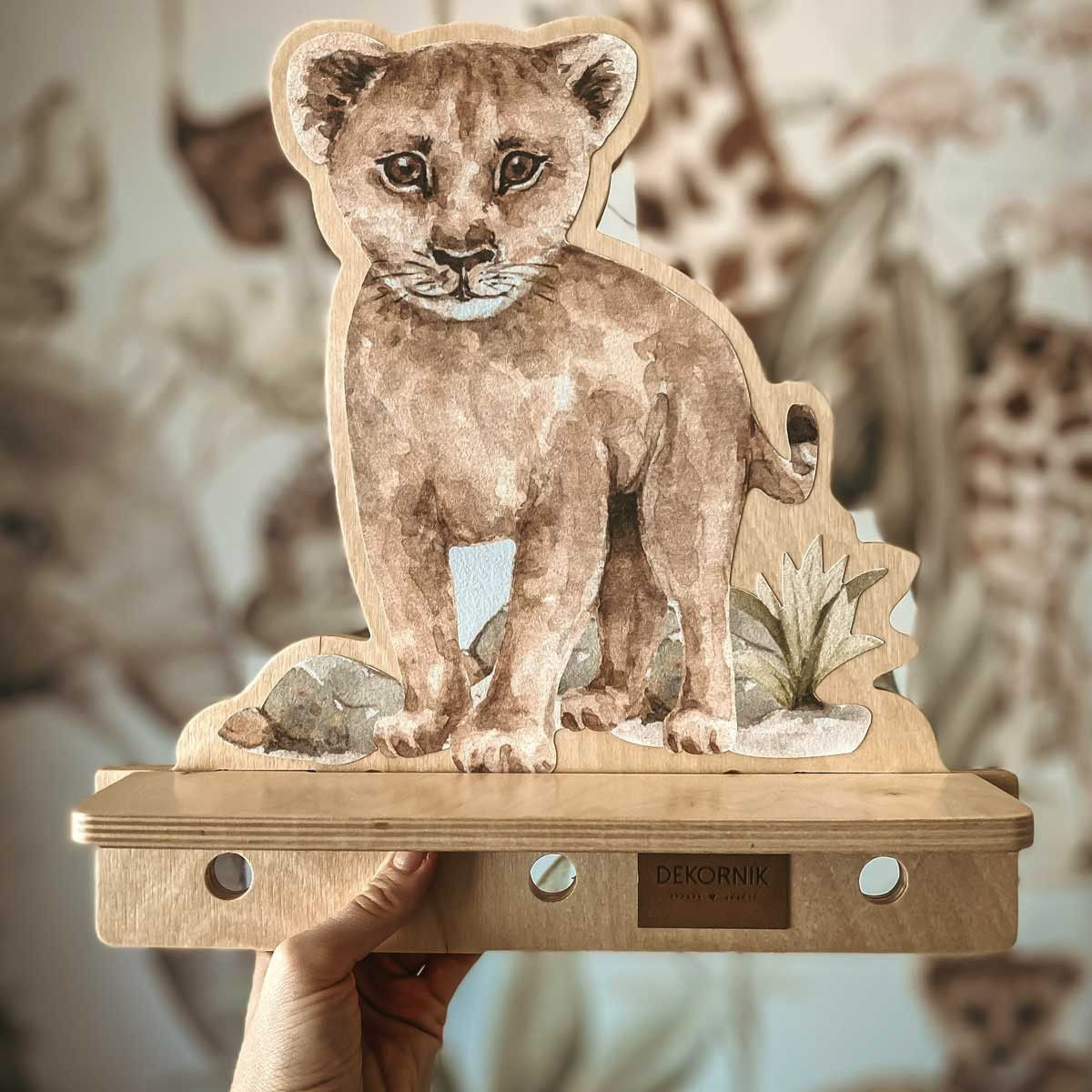 a playful lion wall shelf in a bright kids room with toys on the pegs