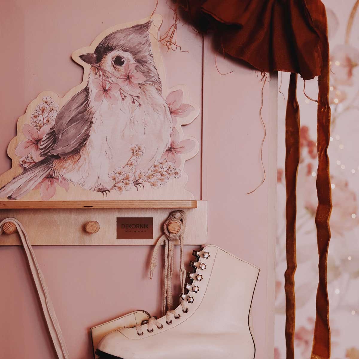 a playful dinosaur mini wall shelf in a sunlit kids room with a backpack hanging from a peg