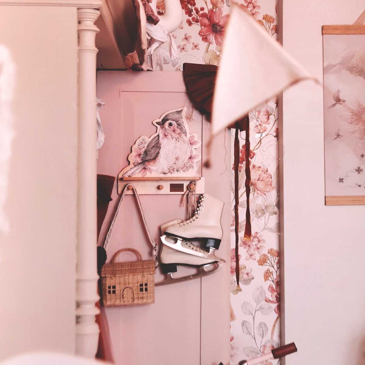 elegant minimalist bird wall shelf with three pegs in a refined nursery setting