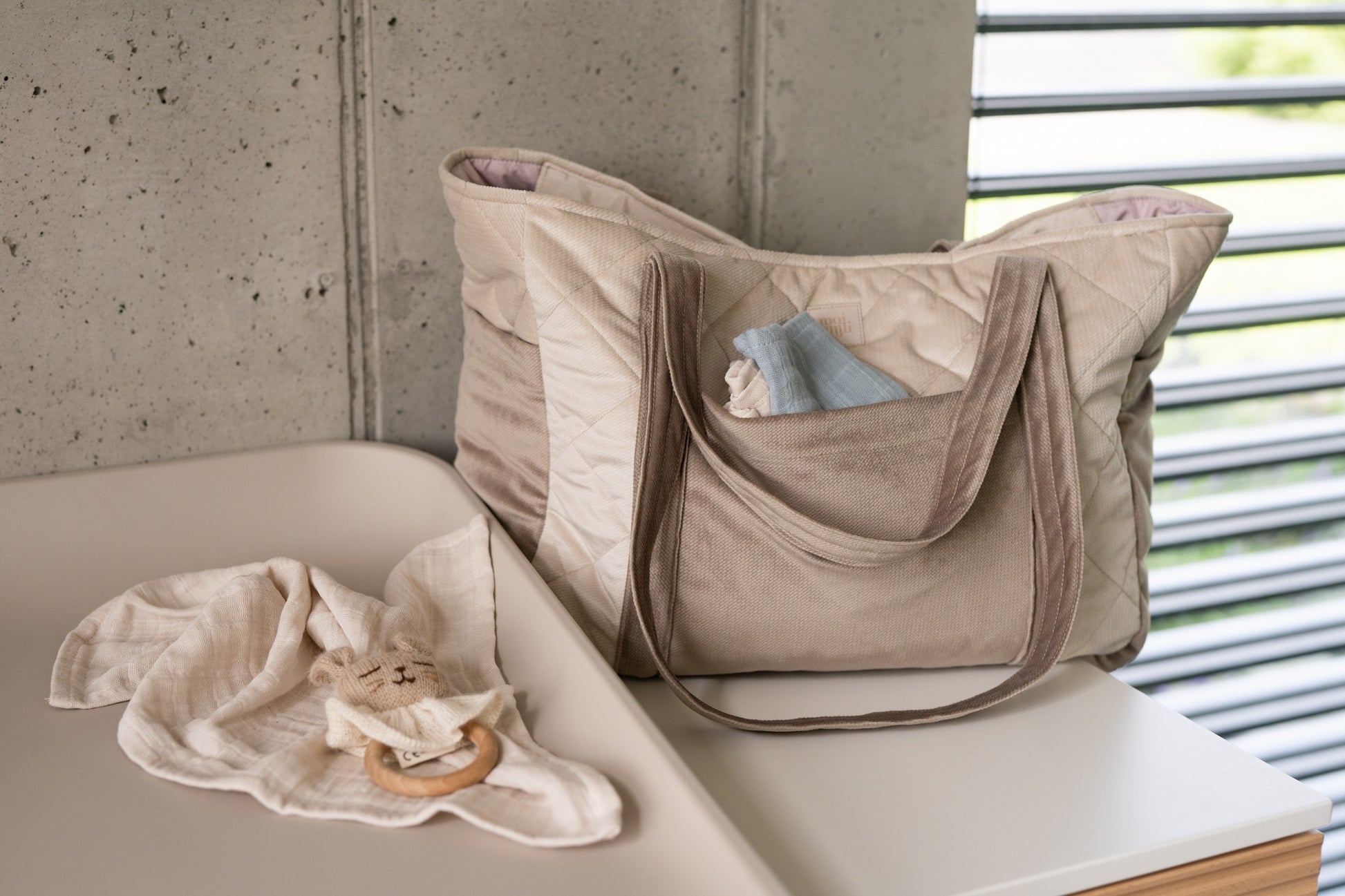 bold beige mom weekender bag with velvet texture and multiple pockets, stylish and practical for travel