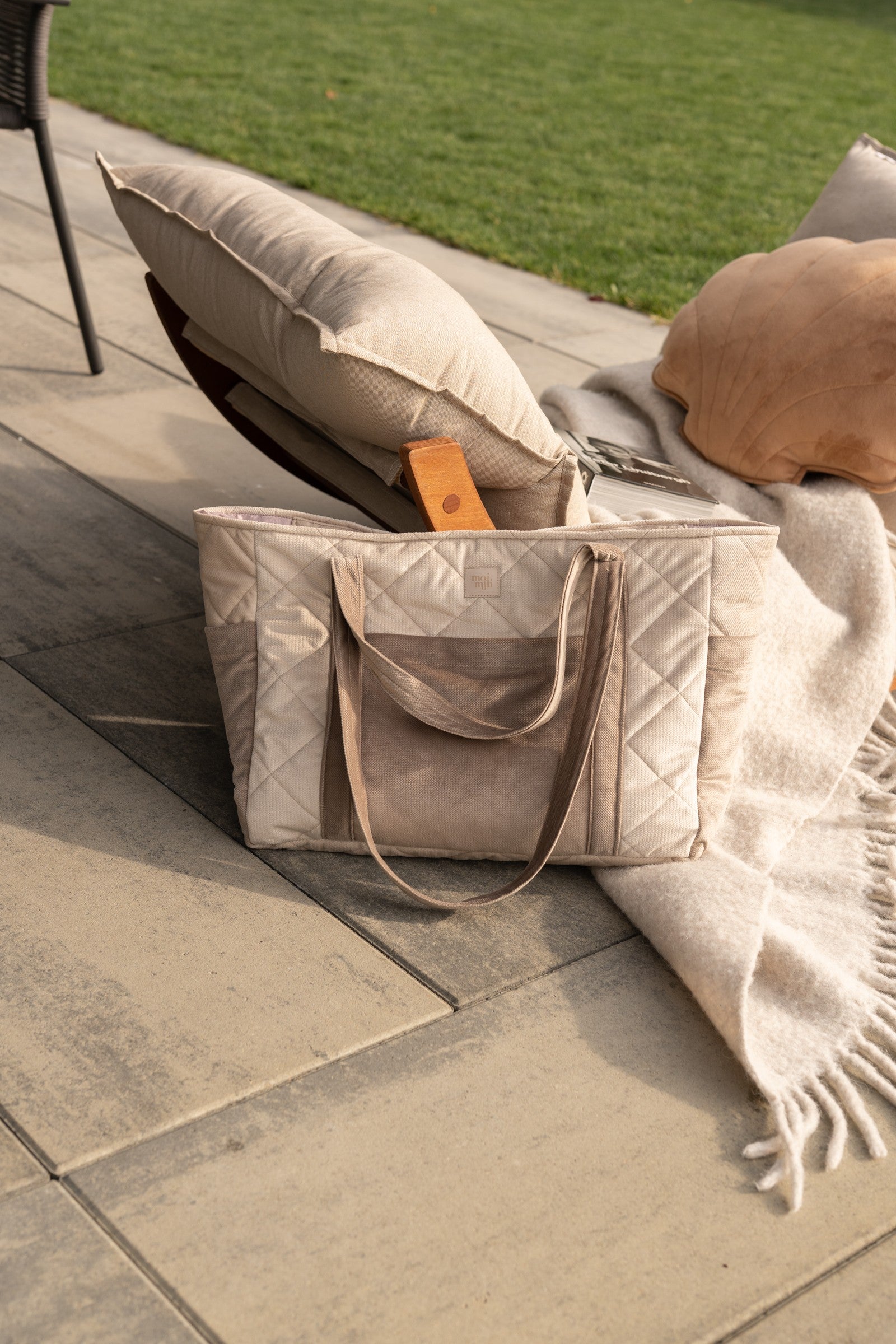 beige mom weekender bag with velvet texture, open to show inner pockets and waterproof lining