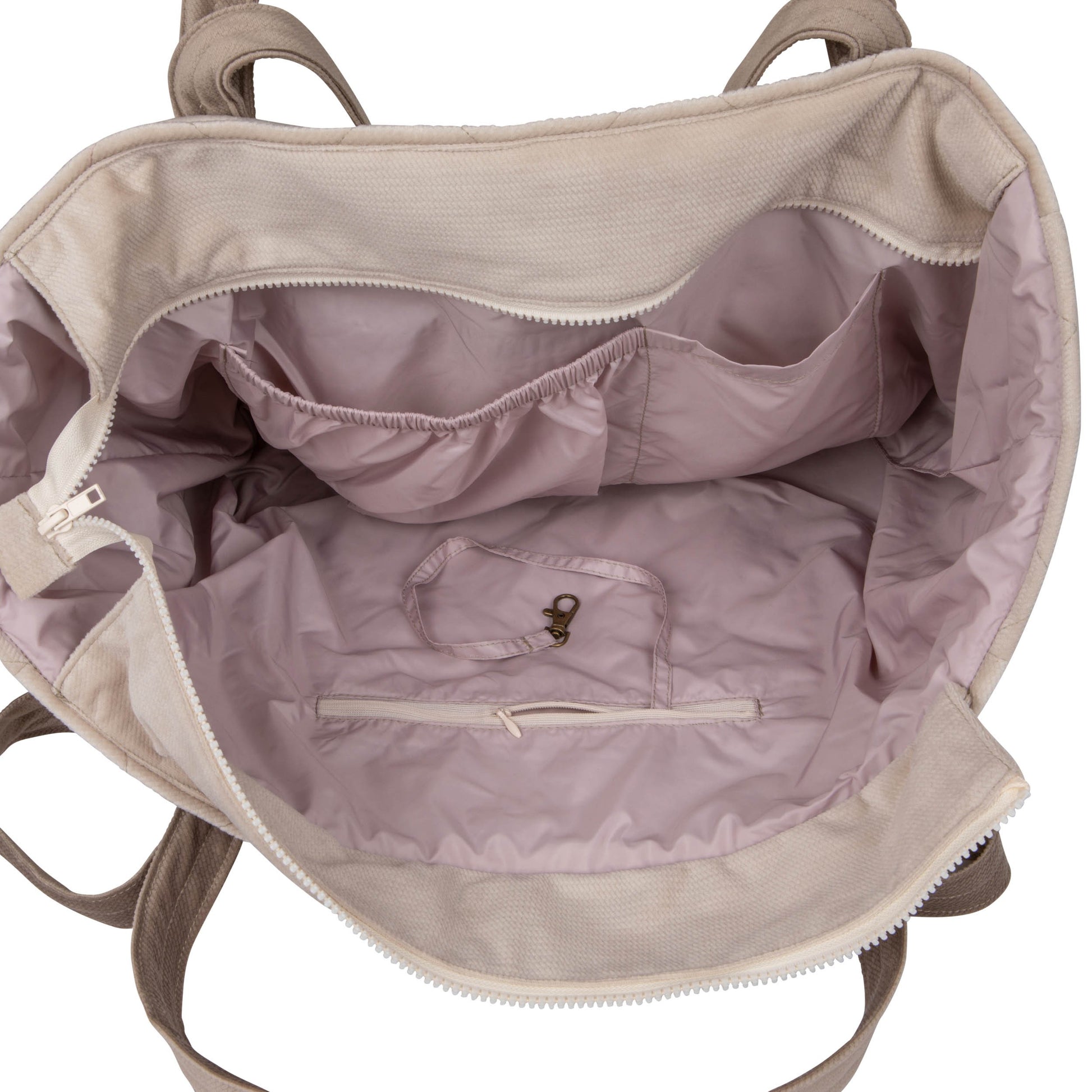 beige velvet weekender bag with dual straps and multiple pockets, laid on a rustic wooden bench