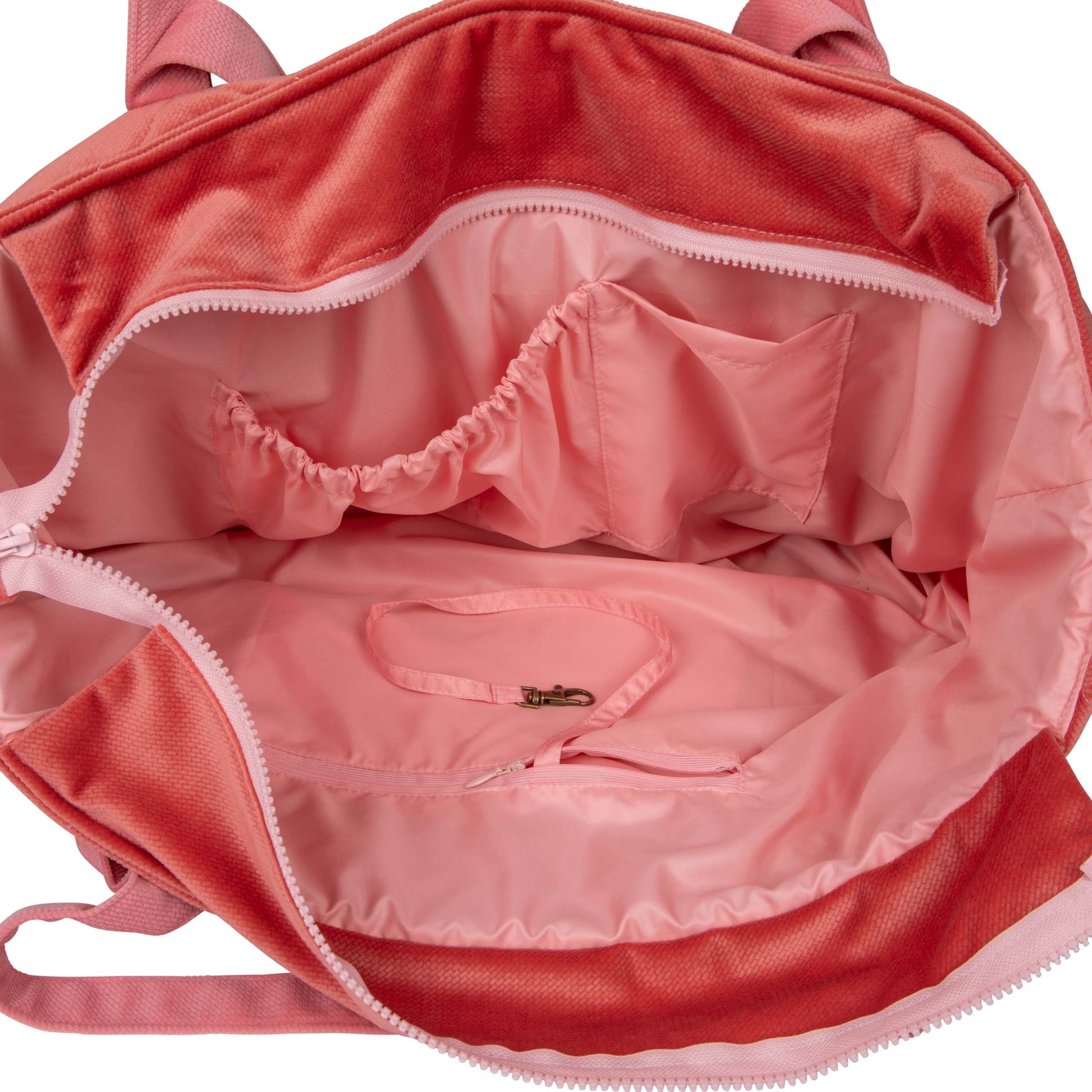 playful pink candy weekender bag with velvet texture, open to show inner pockets, perfect for moms on-the-go