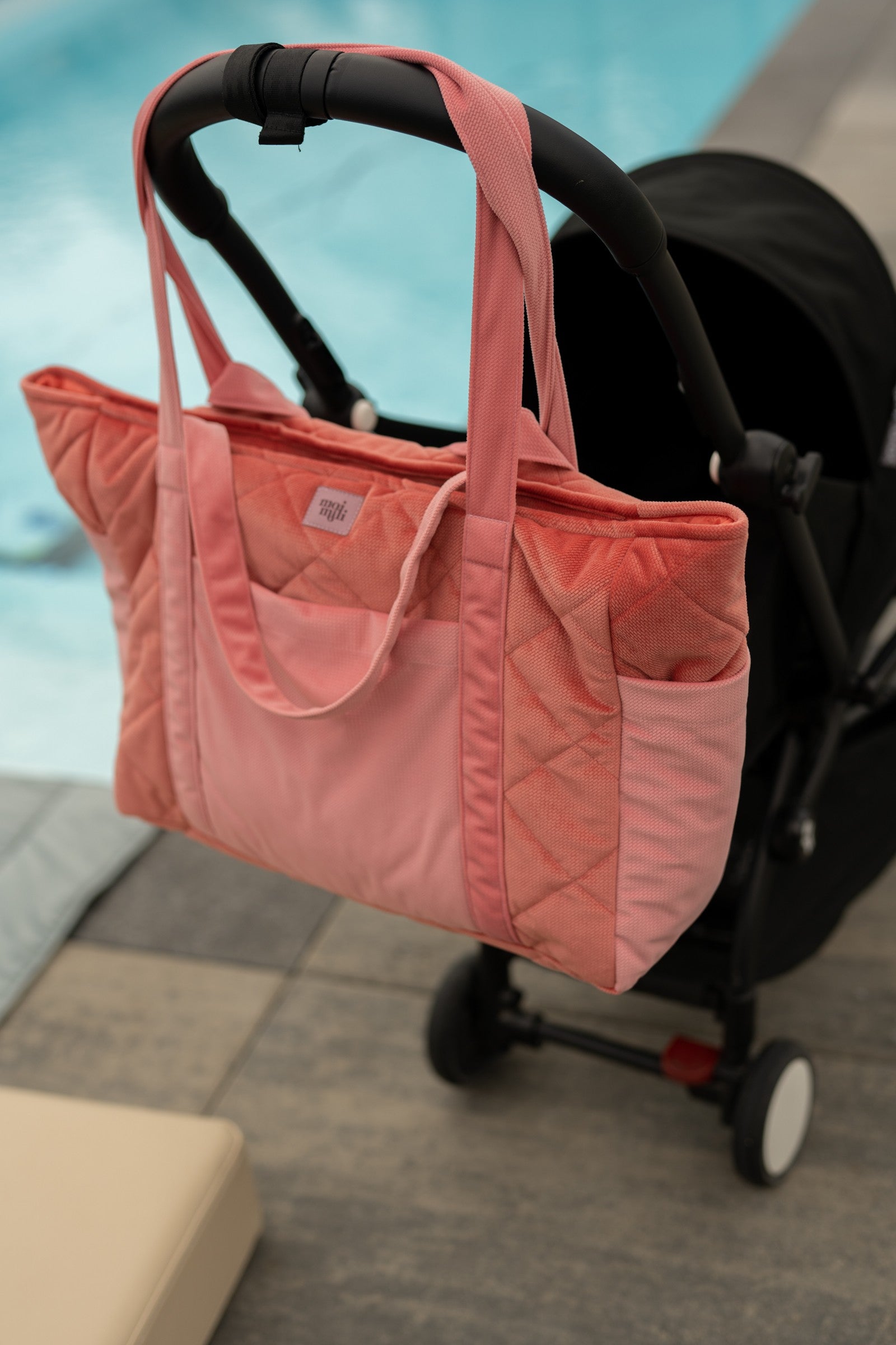 elegant velvet weekender bag in candy pink with gold zipper and structured pockets, perfect for maternity or travel