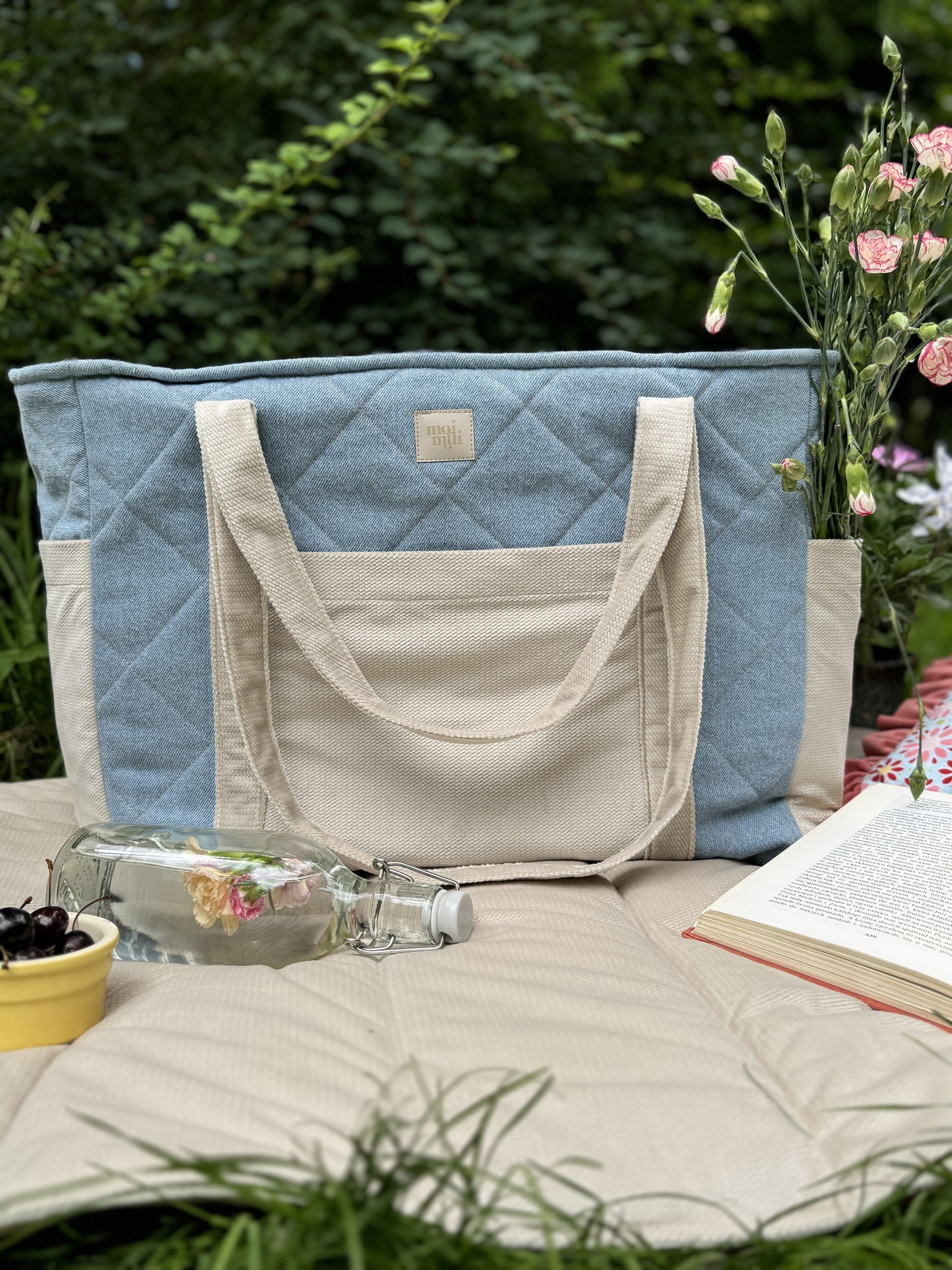 bold blue jeans weekender bag with velvet accents, open to show spacious interior and multiple pockets