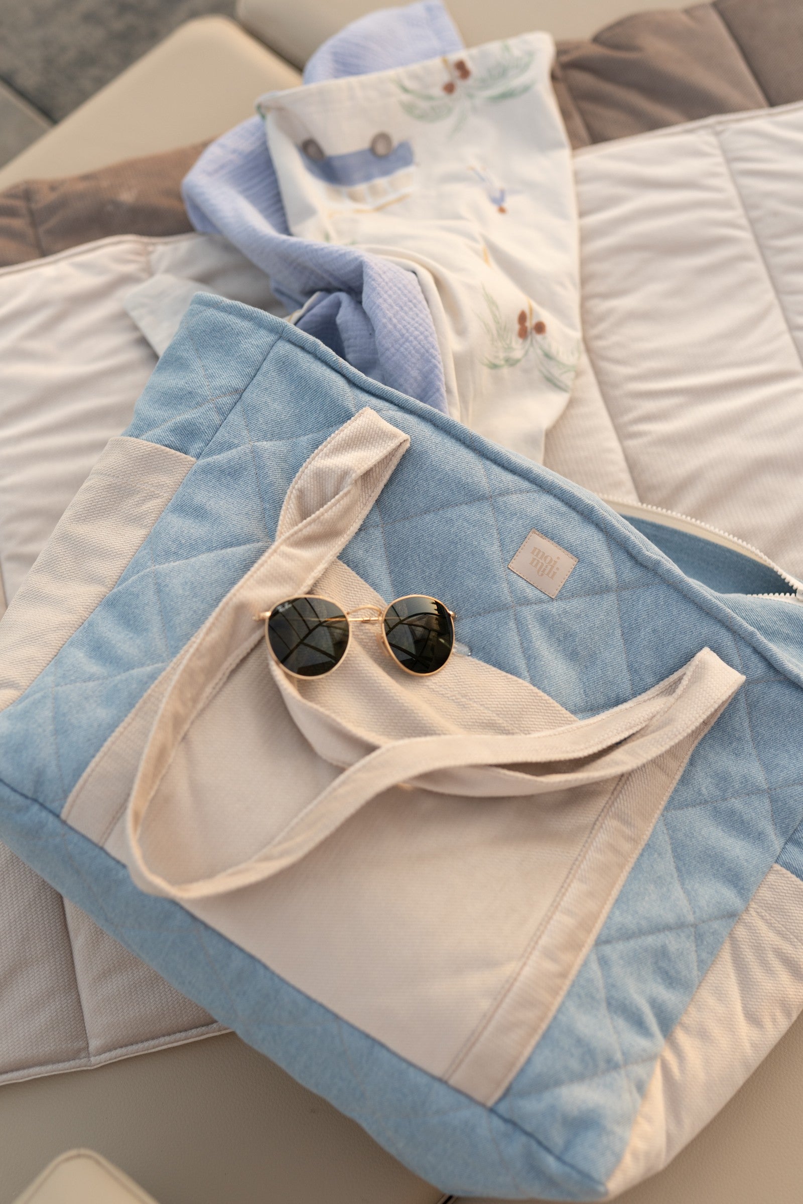 elegant denim weekender bag with velvet accents, open to show organized pockets and waterproof lining