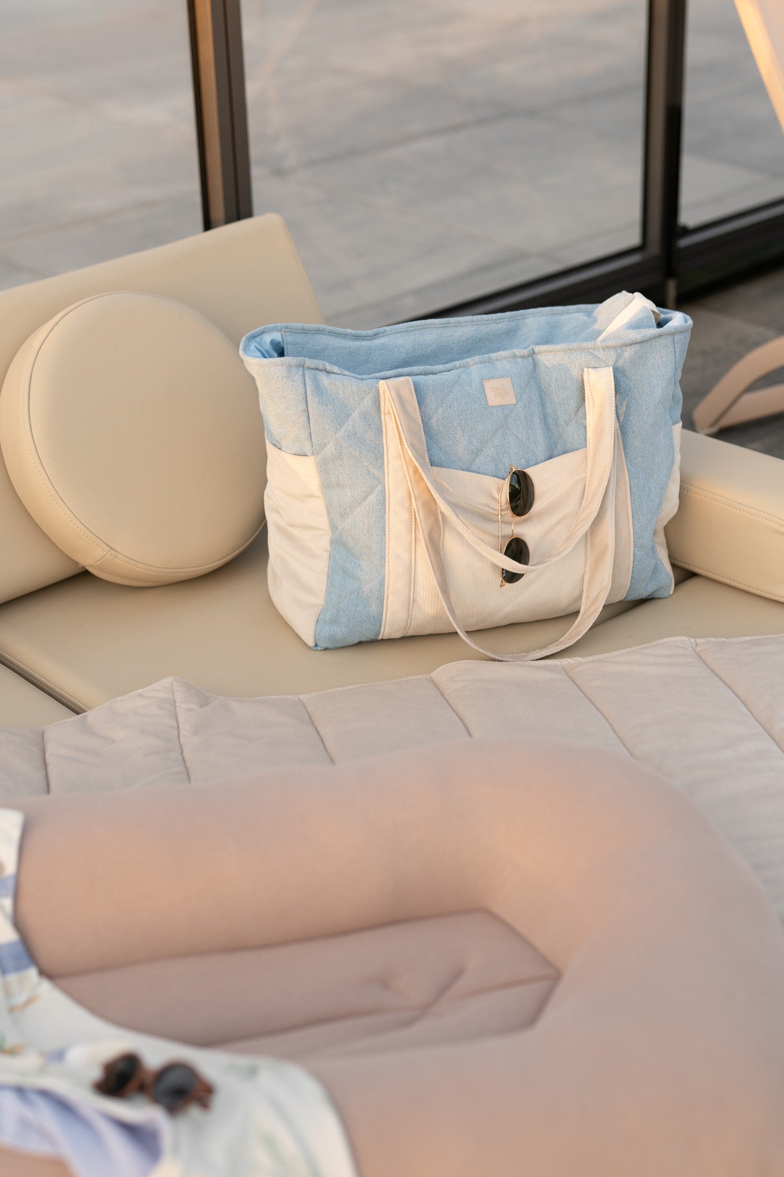 stylish denim weekender bag for moms with velvet trim, open to show roomy interior and multiple pockets