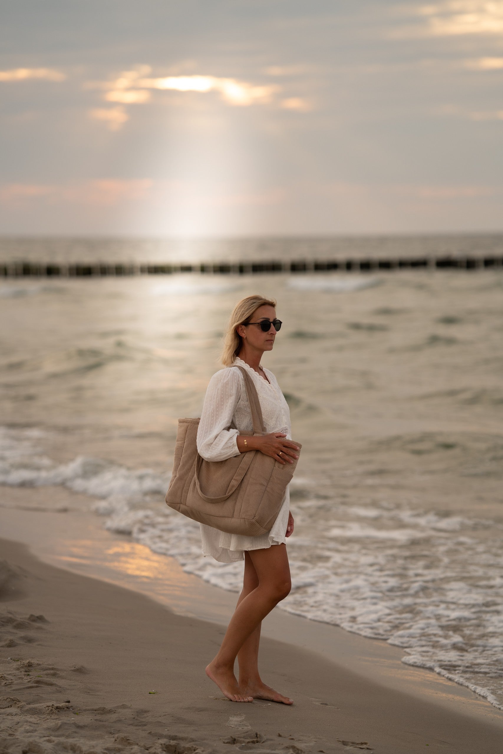functional latte weekender bag with velvet exterior and waterproof lining, showcasing multiple pockets for organization