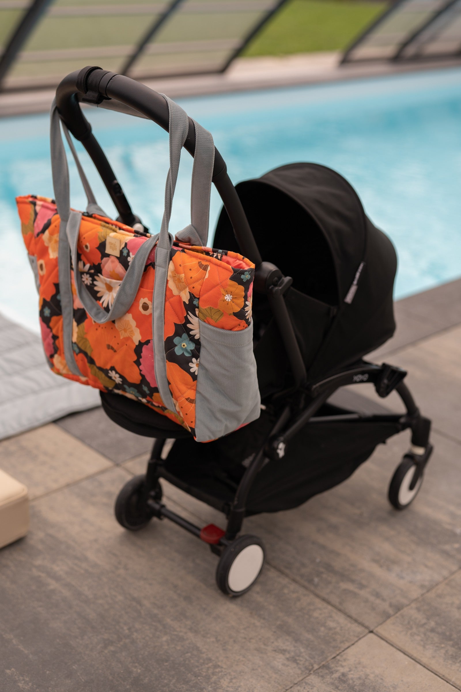 playful floral weekender bag with velvet texture, open to show inner pockets, perfect for picnics or baby essentials