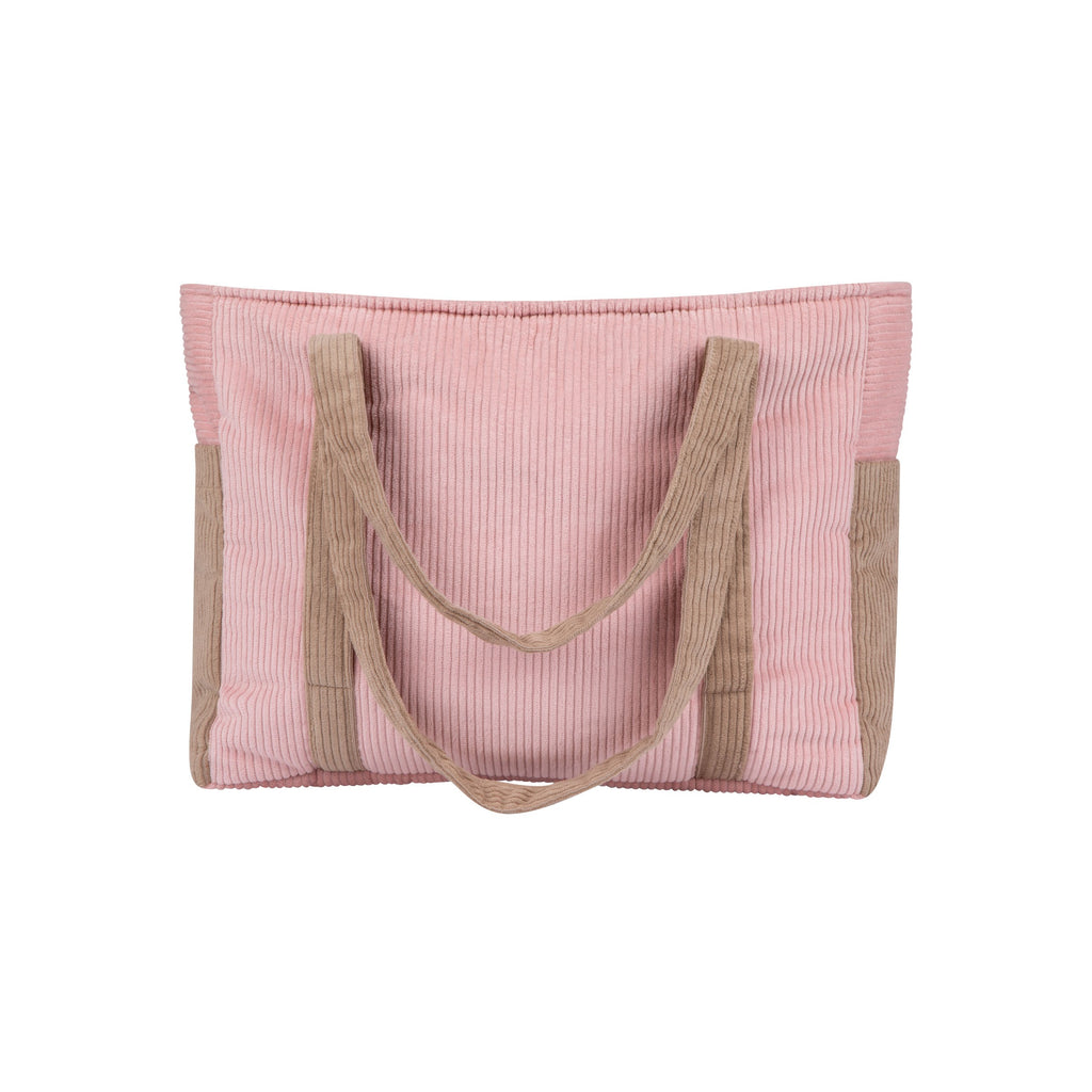 pink coffee weekender bag with velvet texture and dual straps, laid on a rustic wooden bench with soft morning light