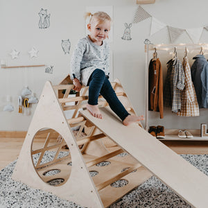a soft-lit view of the montessori climber with ramp, inviting quiet and cozy play in a nursery corner