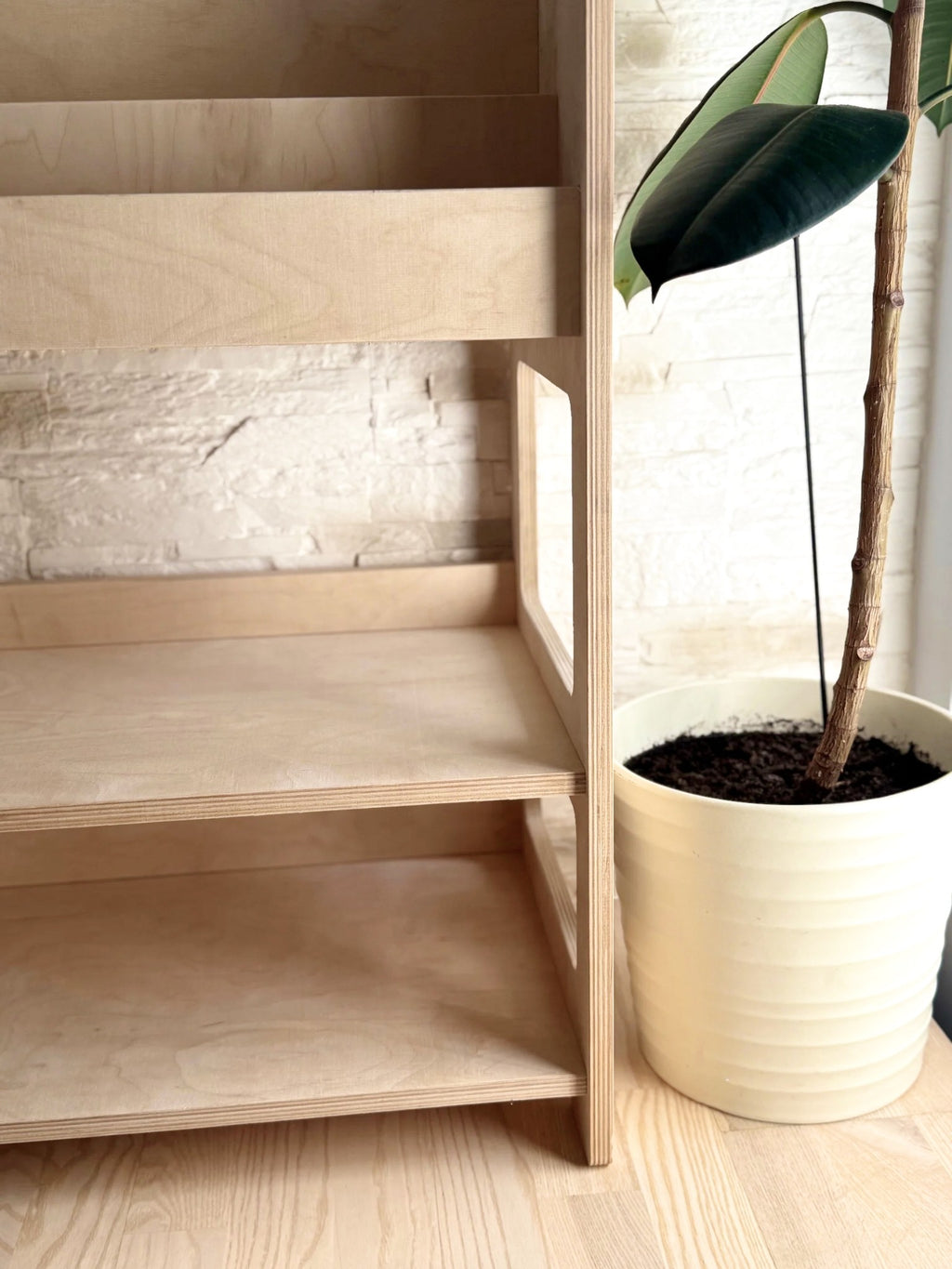 bold front-view of the montessori bookshelf showcasing its sturdy birch frame and deep toy storage