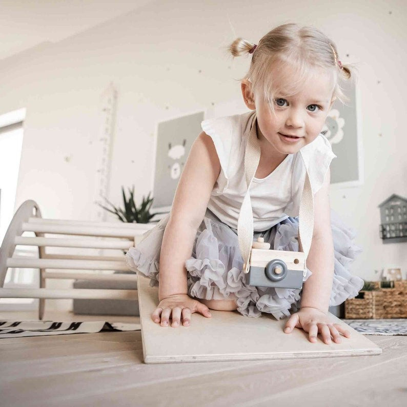 elegant montessori climbing arch in natural wood, showcasing its smooth curves and sturdy design for refined play