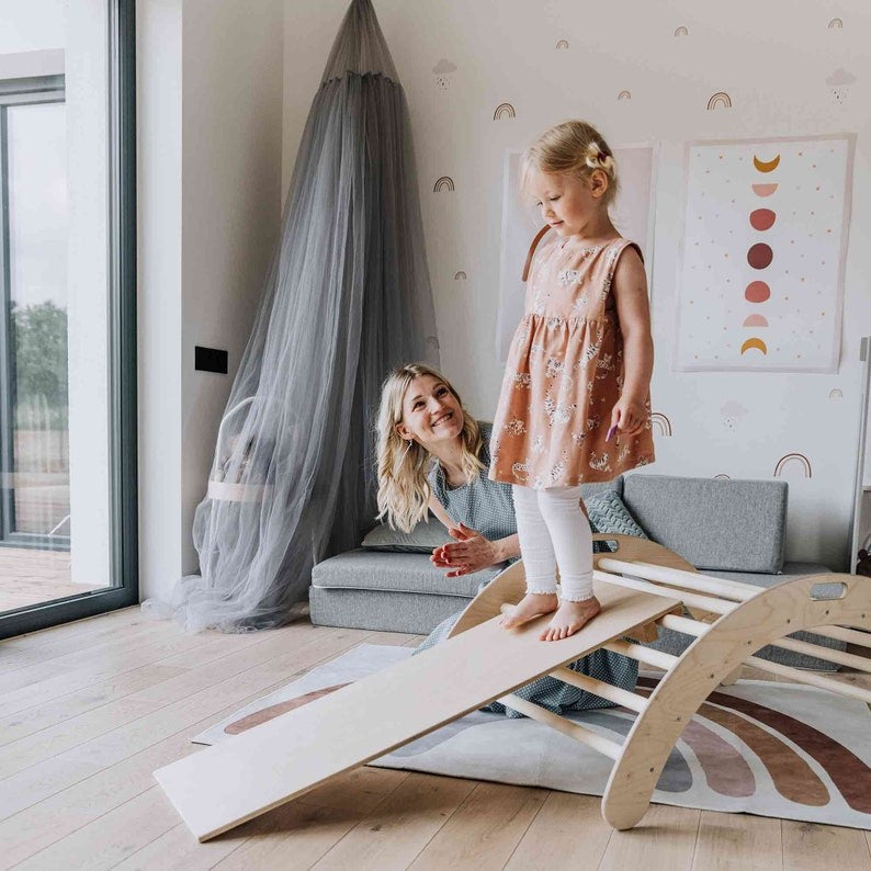 elegant montessori climbing arch with ramp in natural wood, showcasing smooth curves and minimalist design for refined play