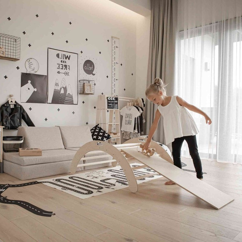 a playful wooden montessori climbing arch with ramp, perfect for kids to climb, rock, and balance, set against a bright, cheerful background