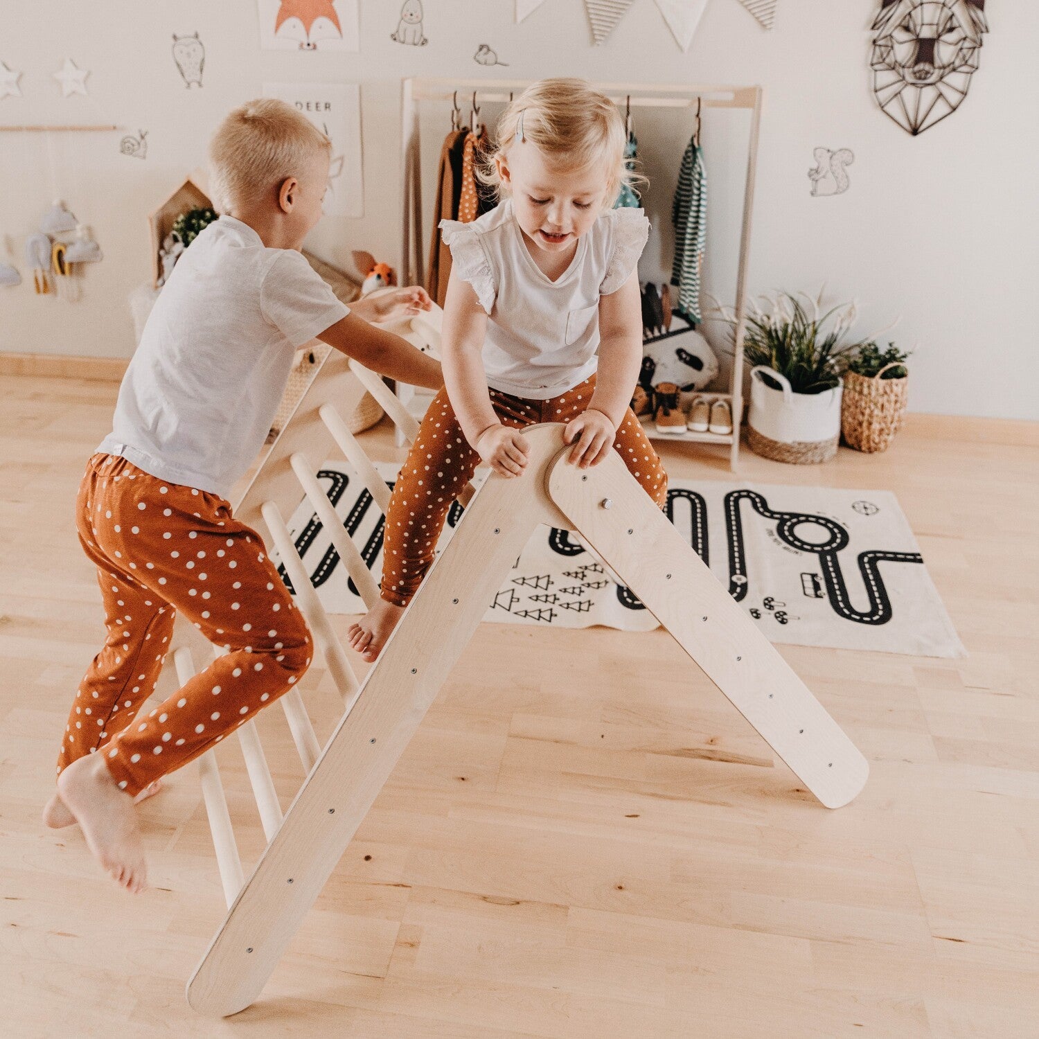 elegant montessori climbing triangle with eight rings, folded for storage in a minimalist home