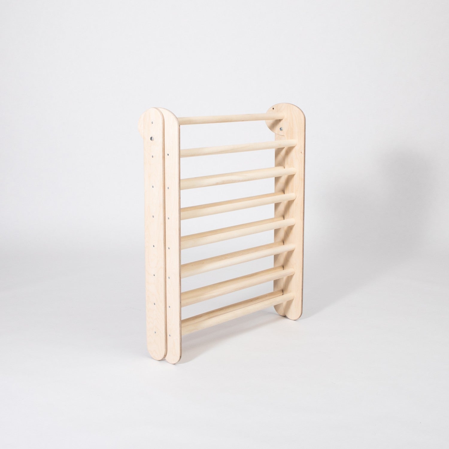 foldable montessori climbing triangle with eight rings, bathed in warm natural light, perfect for toddler adventures