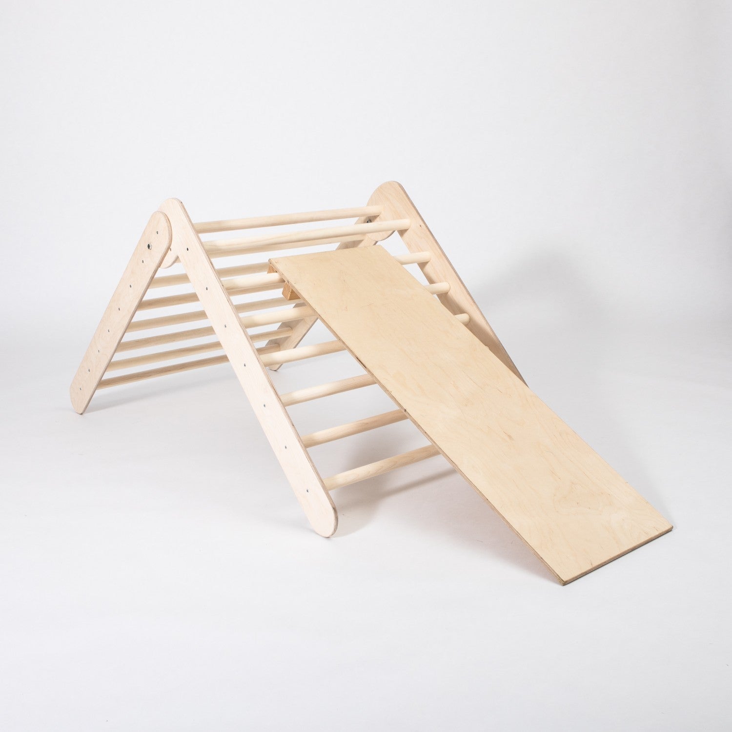 foldable montessori climbing triangle with ramp in natural birch, showcasing sturdy rings and smooth slide surface for toddlers