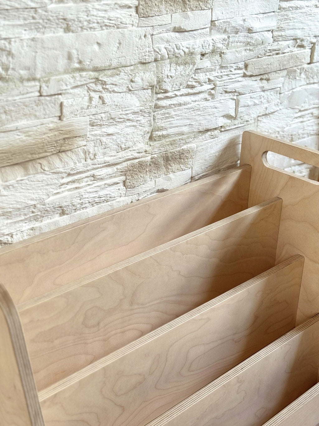 practical kids book stand in a bright playroom showing easy book access