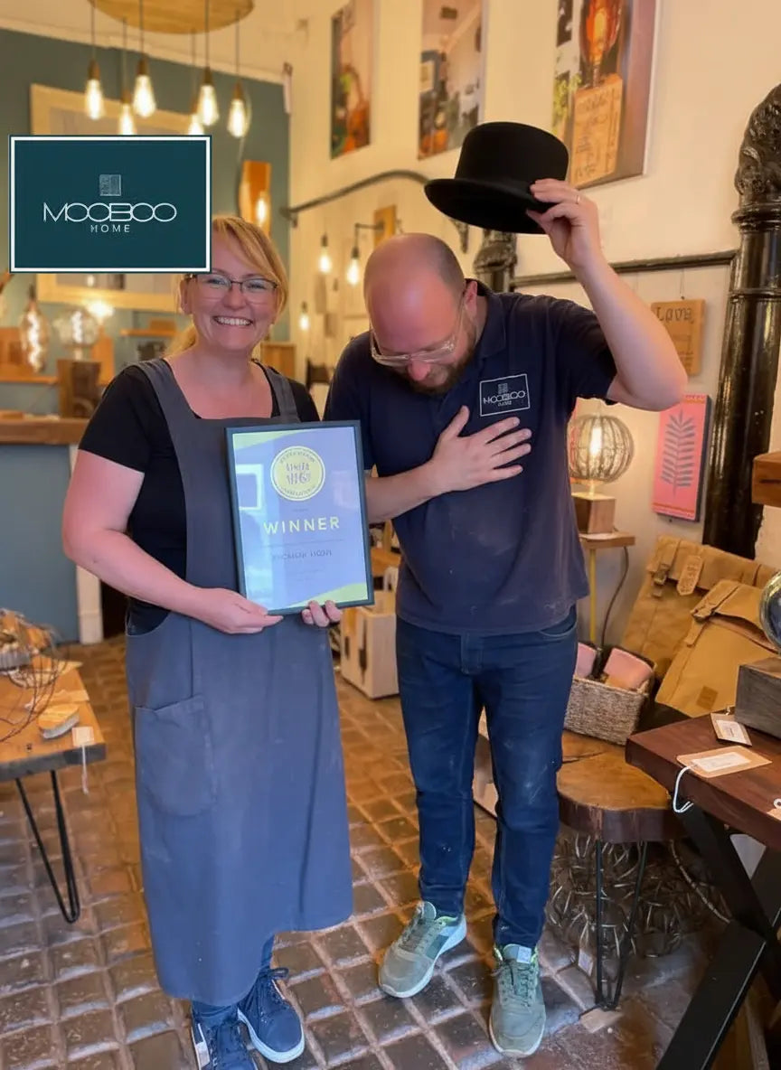 Two people in a store with one holding an award, featuring the Mooboo Home brand logo on sostter.com