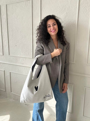 bold white moon bag heart held confidently against a dark backdrop