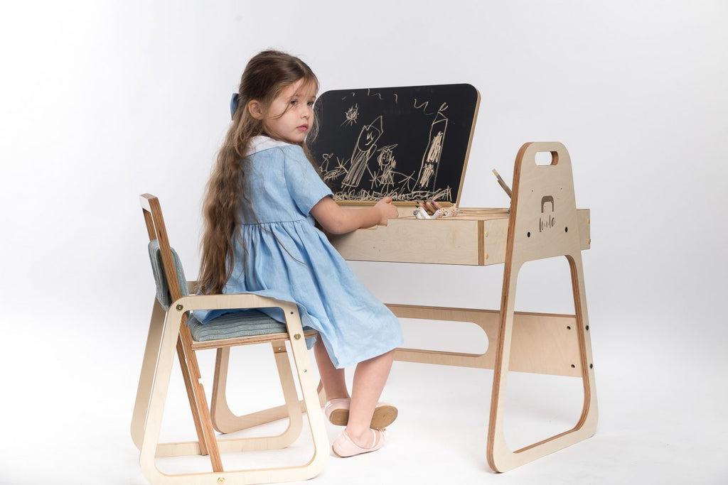 bold modern julle kids art table with chalkboard and paper roll in a bright playroom