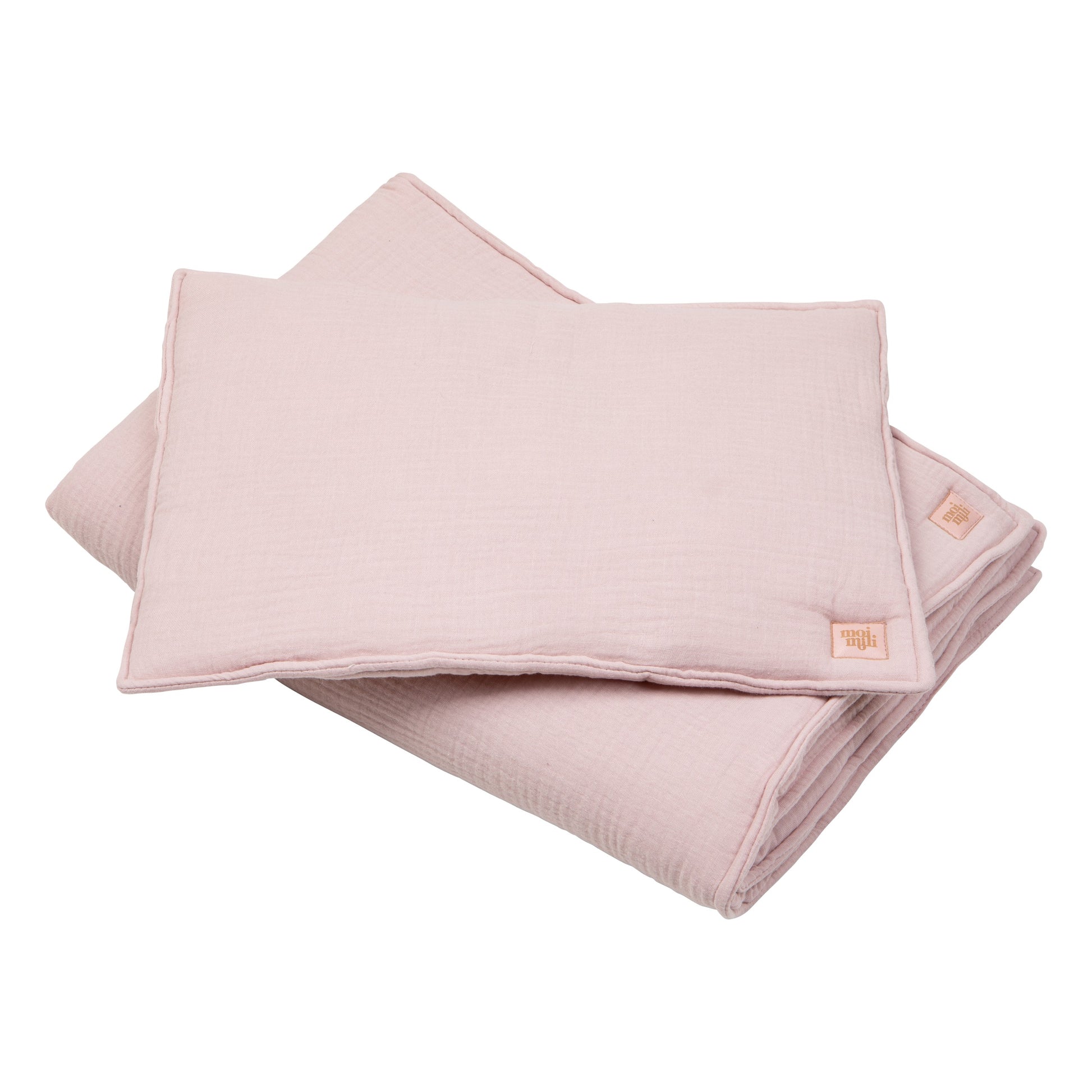 soft baby pink muslin blanket and pillow set draped gently over a crib, perfect for cozy naps