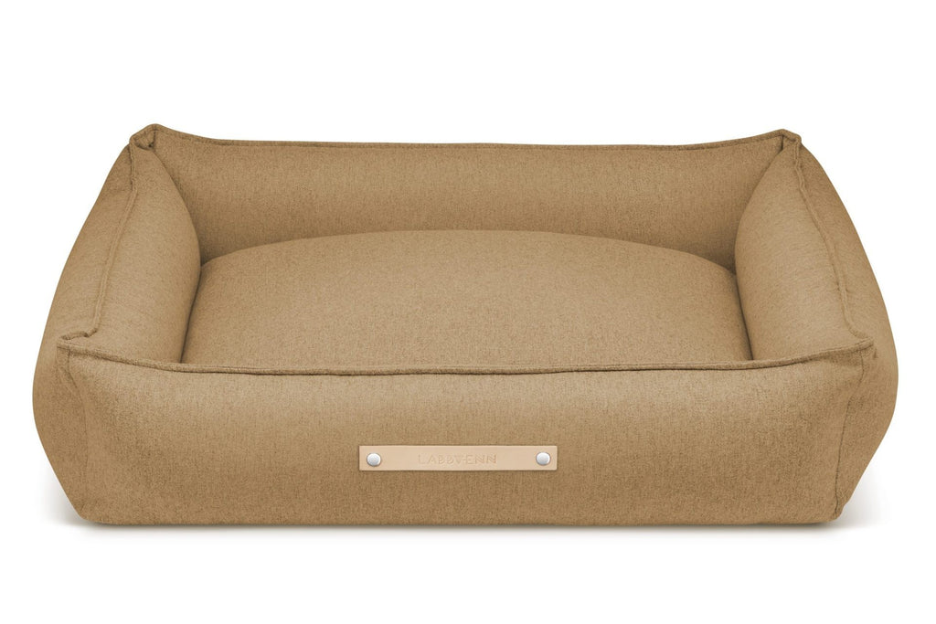 soft biscuit-colored dog bed with a cozy cotton inlett in warm morning light