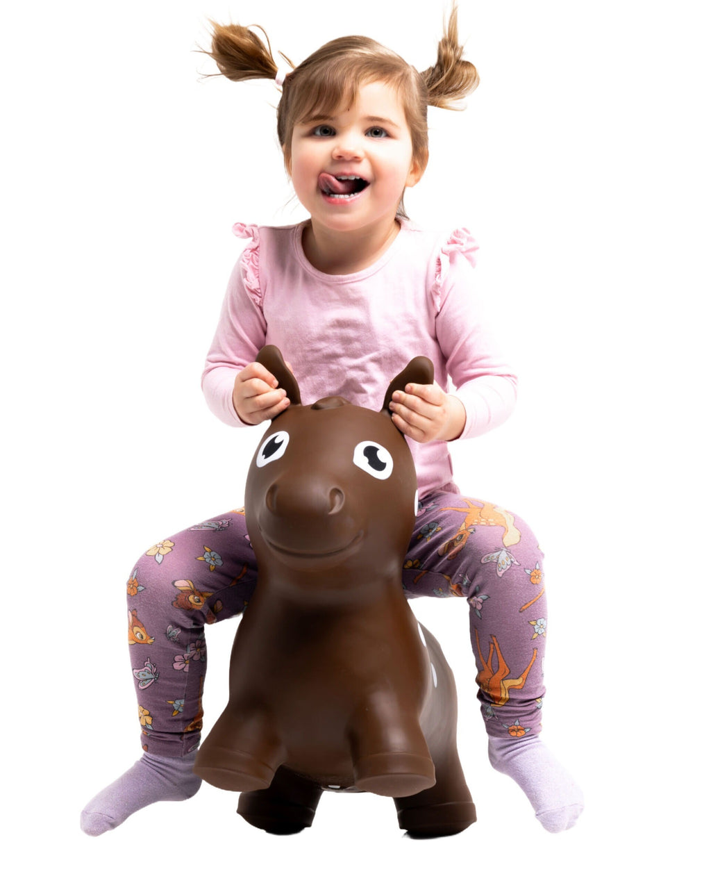 confident toddler bouncing on a sturdy brown horse hopper toy indoors
